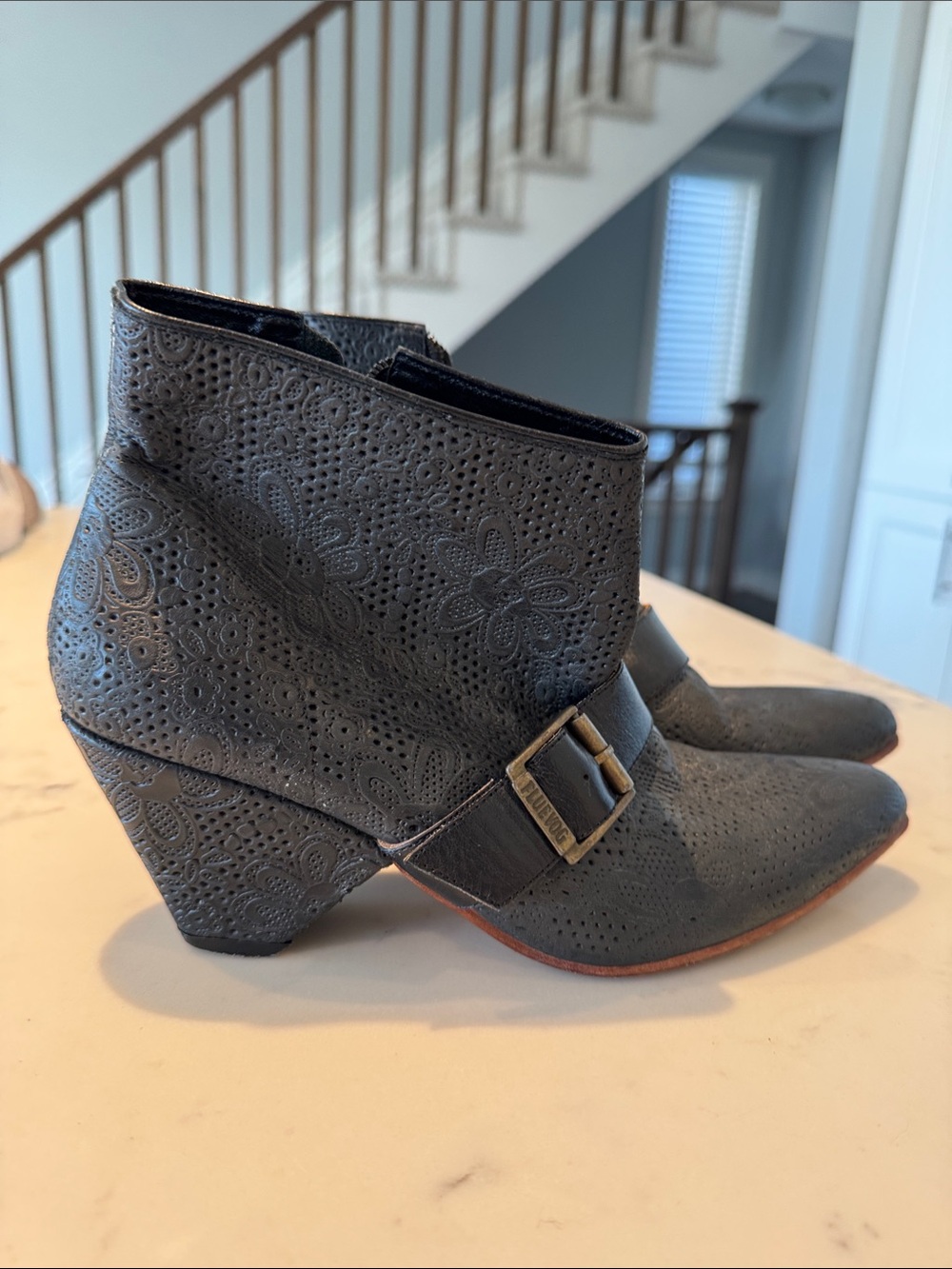 John Fluevog Black “Determination” perforated Floral Buckle Ankle Boots